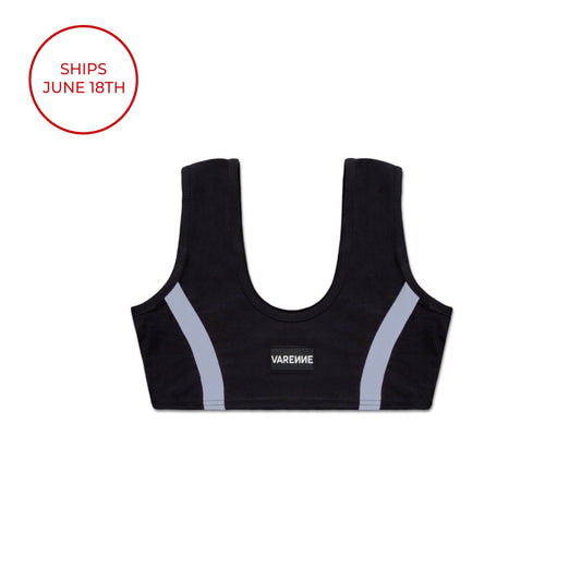 flatlay photo of a black sports bra with the VARENNE logo in the centre and a curved, vertical grey-blue stripe on either side