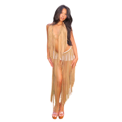 woman standing against a white background wearing a beige leather bikini top with hip length fringes along the neckline and a matching belt with calf length fringes over white mini shorts.